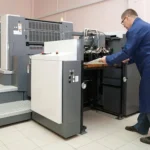 a man doing offset printing in dubai