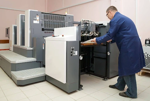 a man doing offset printing in dubai